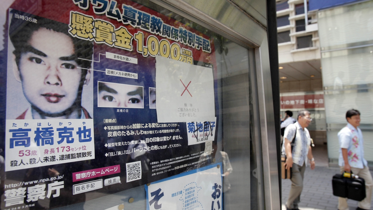 A "wanted" poster of former Aum Shinrikyo cult member Katsuya Takahashi is displayed outside a police station in Tokyo.