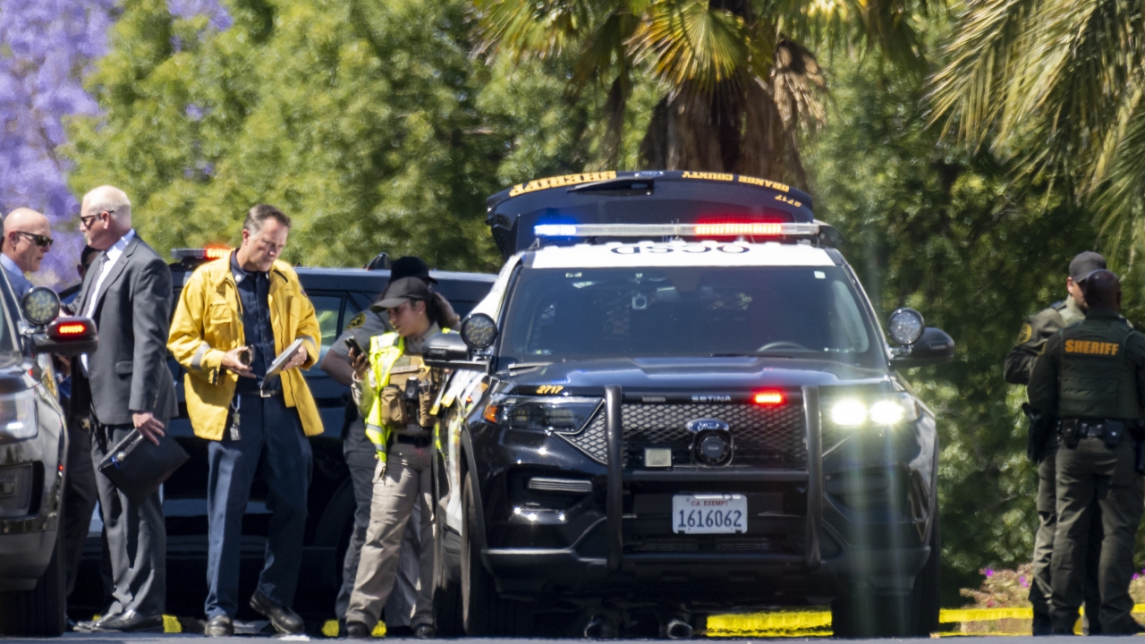 nvestigators gather outside the Geneva Presbyterian Church in Laguna Woods, California.