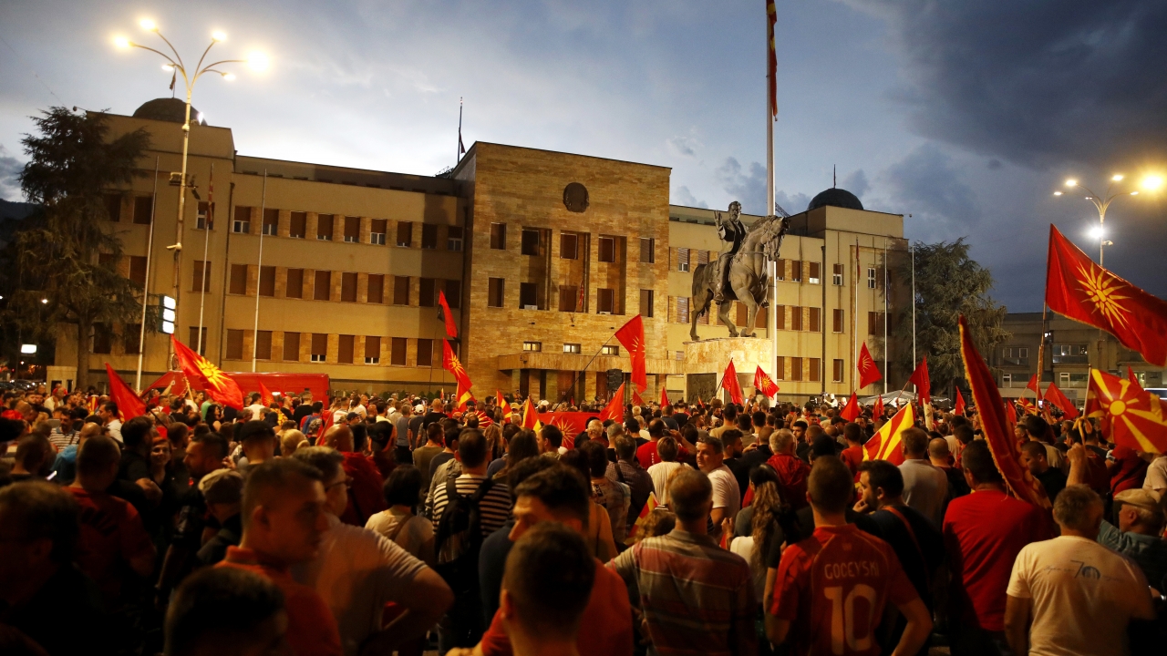 A crowd of people protest in front of the parliament building in Skopje, North Macedonia