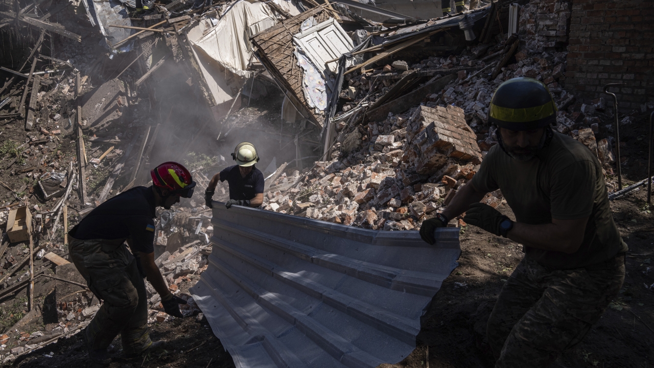 Rescue workers clearing rubble of destroyed house after a Russian attack in a residential neighborhood in Kharkiv, Ukraine