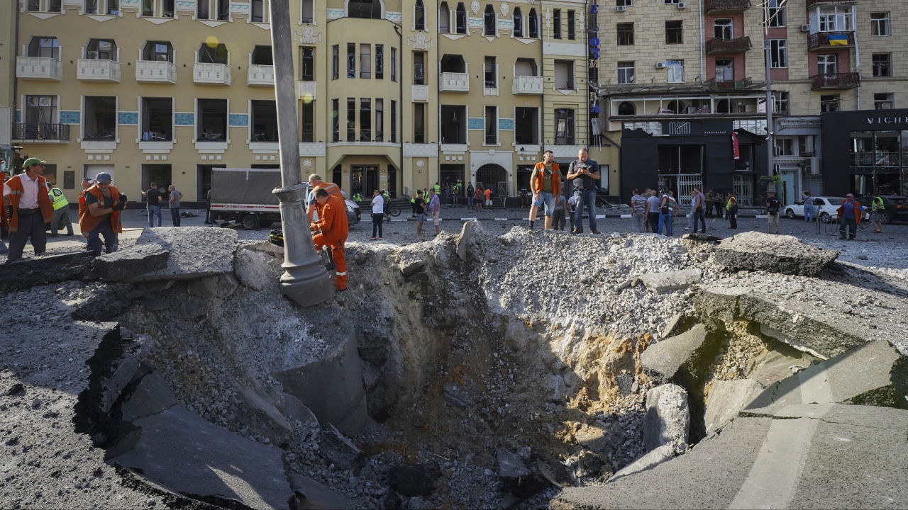 A view of a crater from a night Russian rocket attack, near to damaged buildings in downtown Kharkiv, Ukraine.