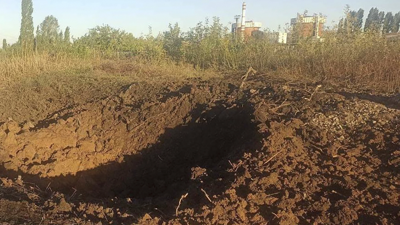 A crater left by a Russian rocket is seen 328 yards from the South Ukraine nuclear power plant