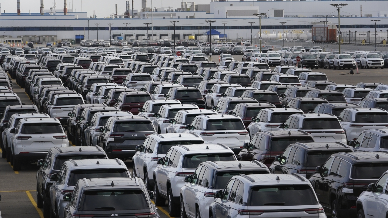 New vehicles are shown parked in storage lots near the the Stellantis Detroit Assembly Complex in Detroit.