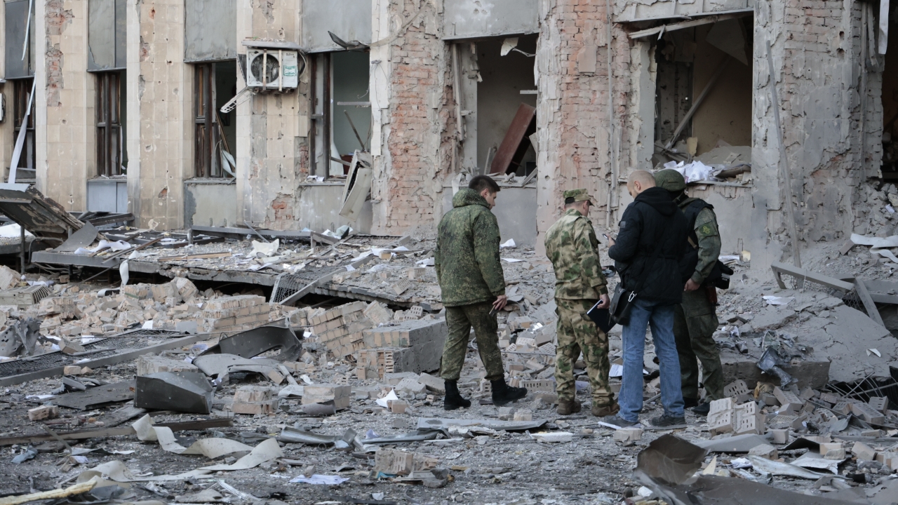 Investigators inspect a site after shelling near an administrative building, in Donetsk, Ukraine.