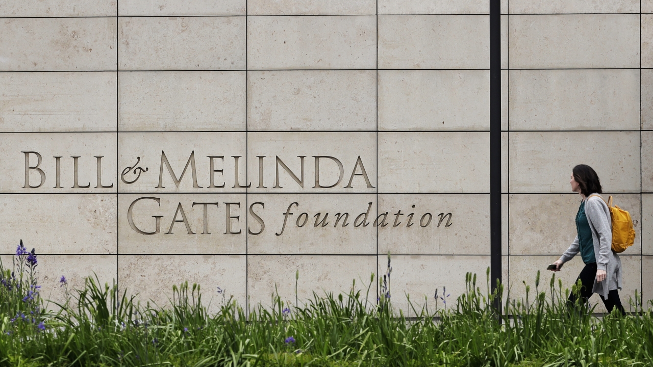A person walks by the headquarters of the Bill and Melinda Gates Foundation.