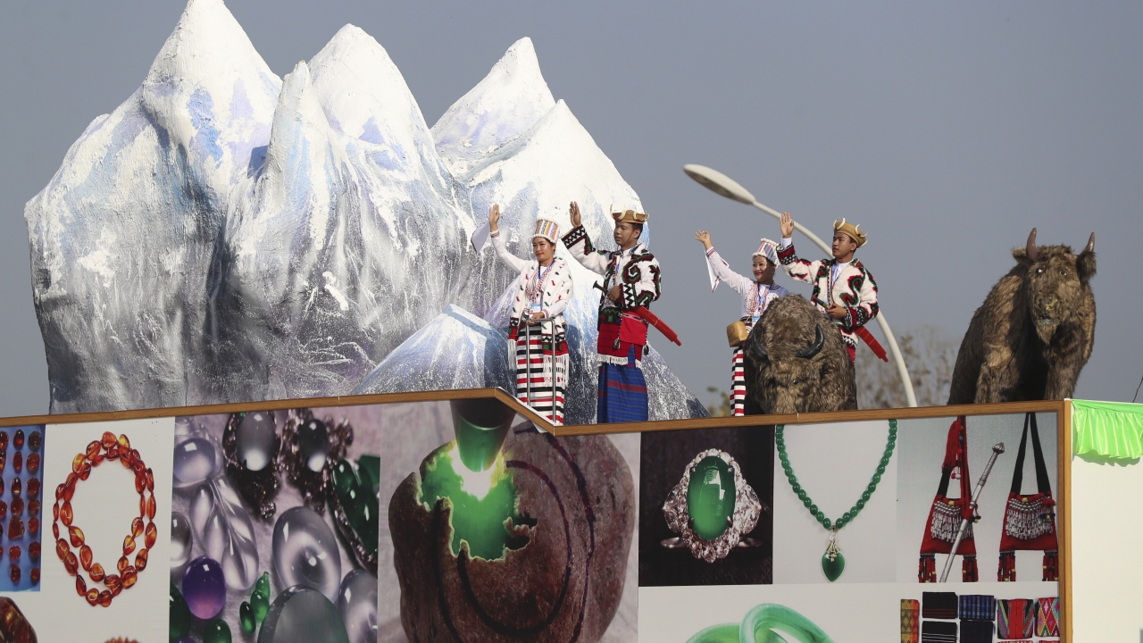 Kachin's traditional artist group performs on decorated truck.