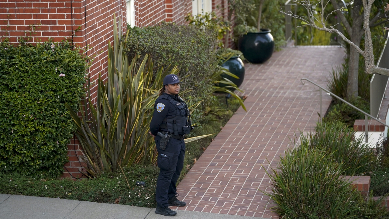 A police officer stands outside the home of House Speaker Nancy Pelosi.