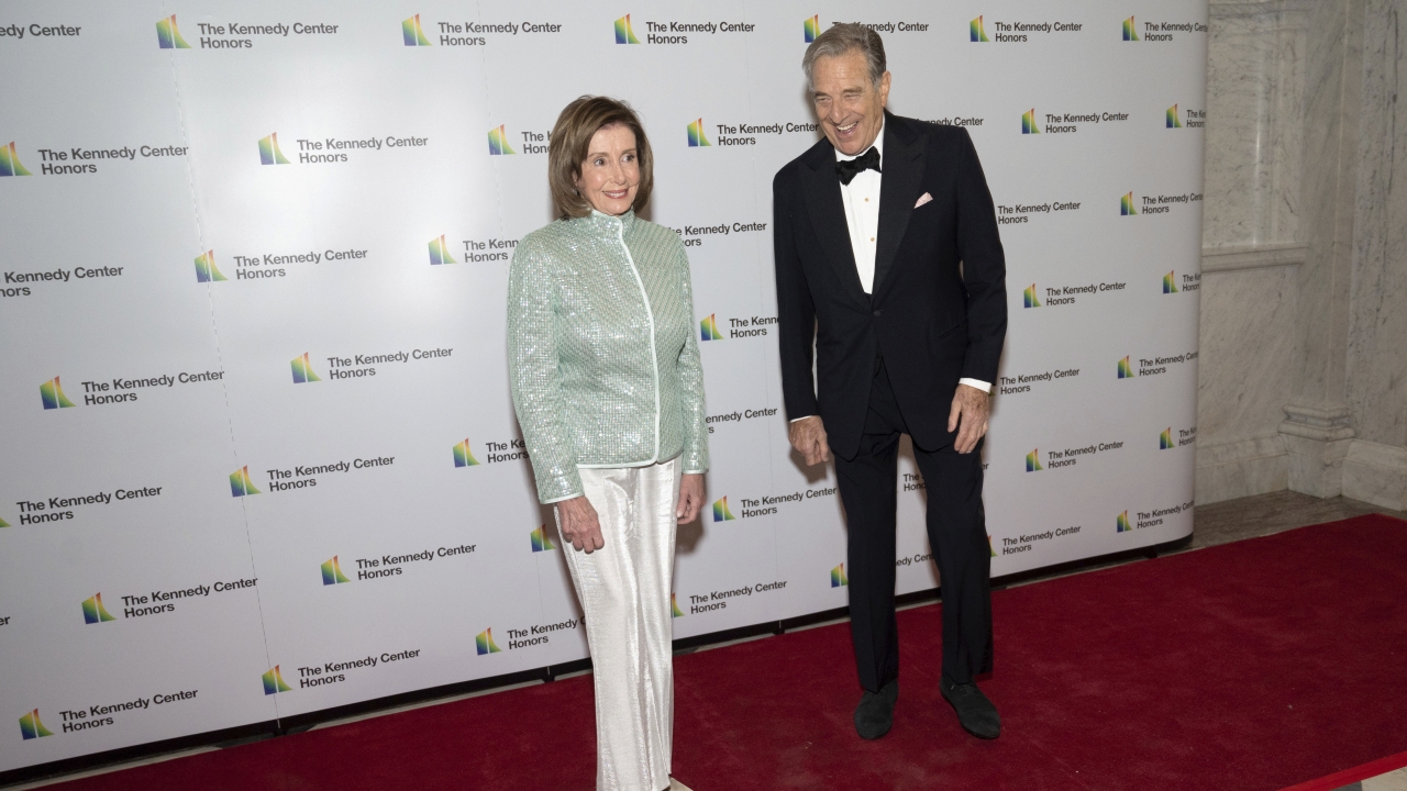 House Speaker Nancy Pelosi, D-Calif., and her husband, Paul Pelosi, pose on the red carpet at the Medallion Ceremony