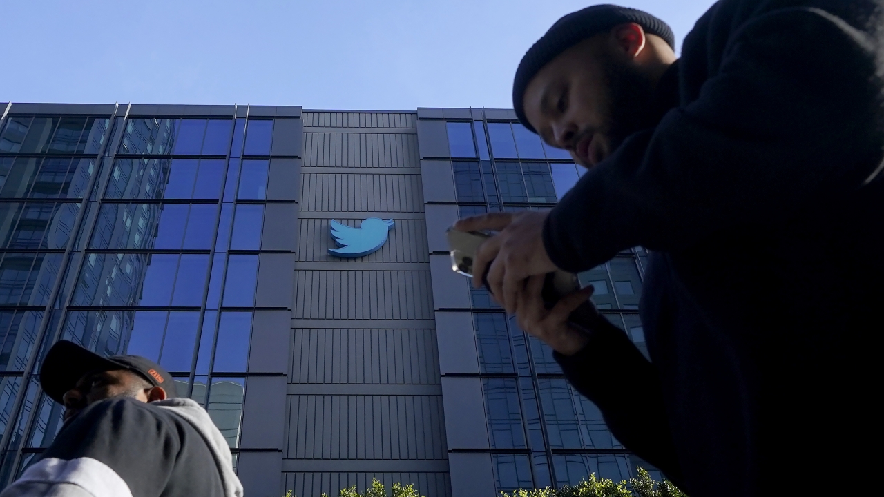 People walk outside Twitter headquarters in San Francisco.