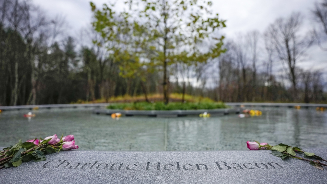 Flowers lay next to a victim's name carved in the stone of a memorial dedicated to the victims of the Sandy Hook shooting.