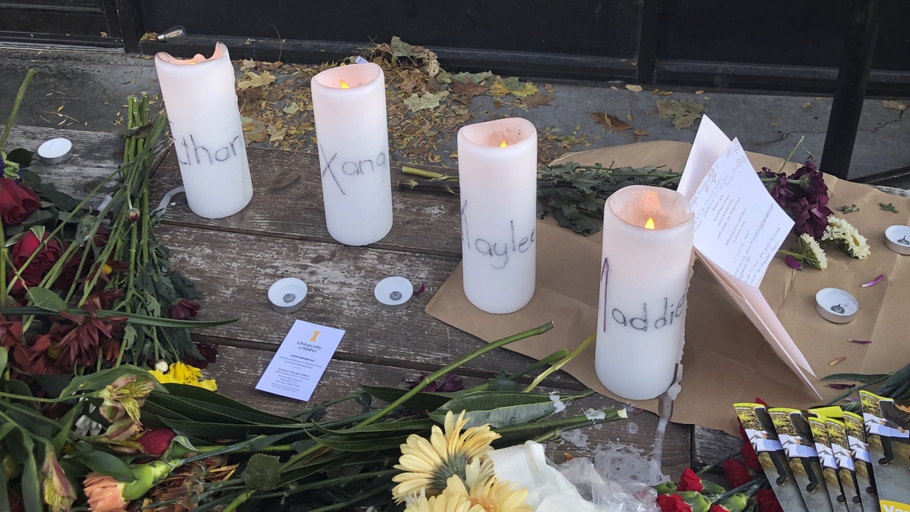 Candles and flowers are left at a make-shift memorial honoring four slain University of Idaho students outside a restaurant