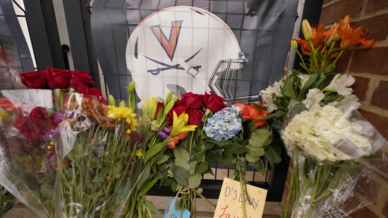 Memorial flowers and notes line walkway at Scott Stadium after three football players were killed in a shooting.