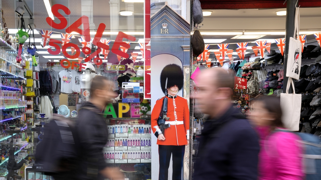 Pedestrians pass a souvenir shop on Oxford Street in London.
