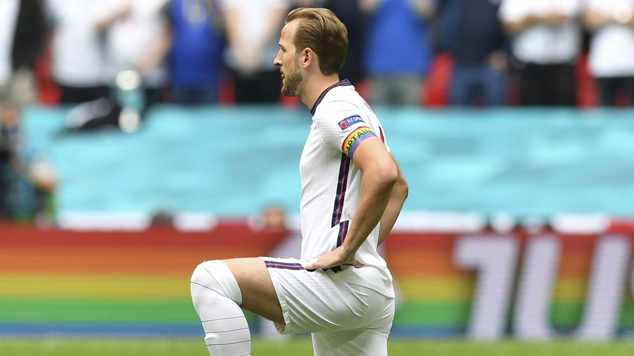England's Harry Kane wears a rainbow armband as he takes a knee during the Euro 2020 soccer championship.