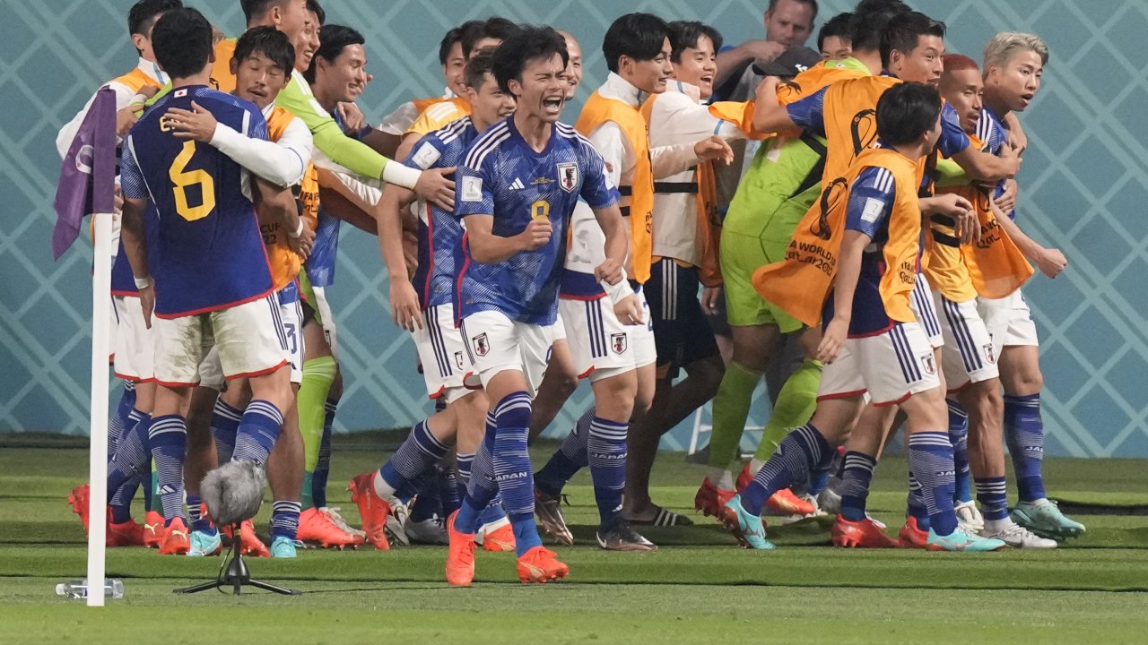 Team Japan celebrates after beating Germany in World Cup.