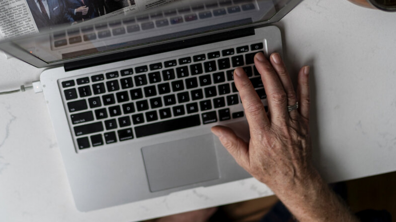 Woman types on her laptop keyboard.