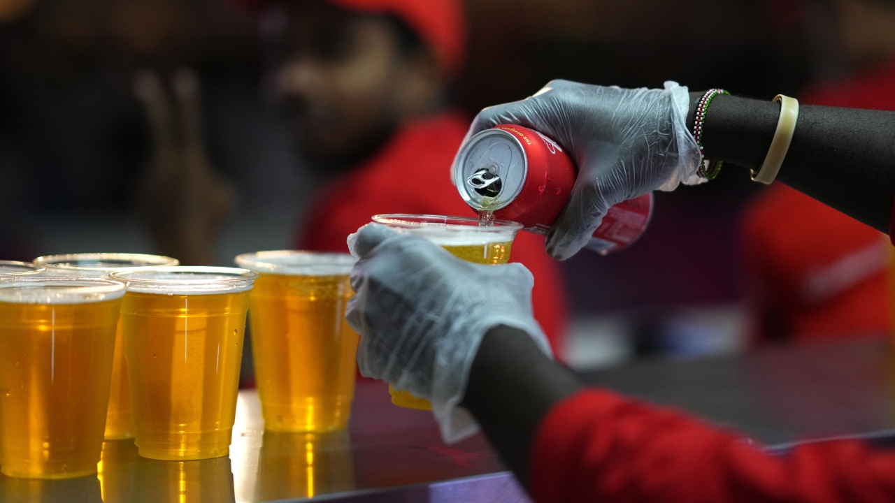 Staff member pours a beer at a fan zone ahead of the FIFA World Cup, in Doha, Qatar.