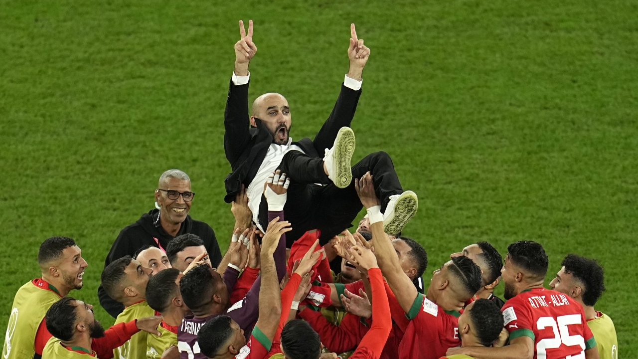 Morocco's head coach Walid Regragui is thrown in the air at the end of the World Cup round of 16