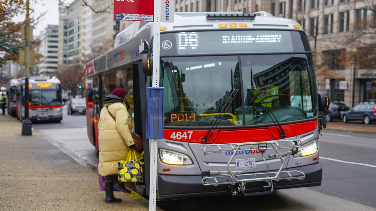 A passenger boards a Metrobus in downtown Washington, D.C.