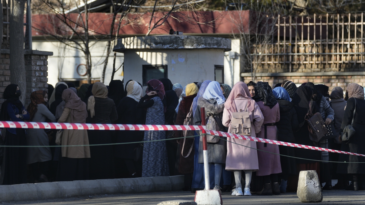 Afghan students queue at one of Kabul University's gates in Kabul, Afghanistan.