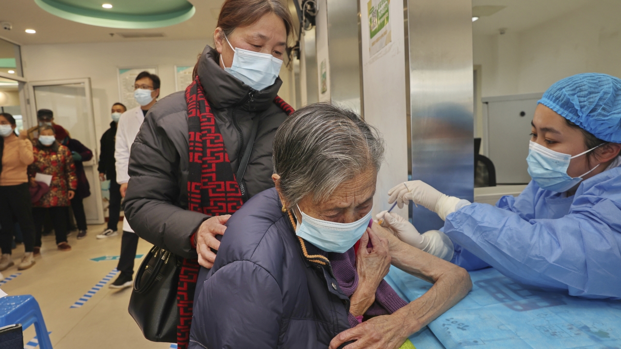 A nurse gives a COVID vaccine to an old woman at a community health center in China.