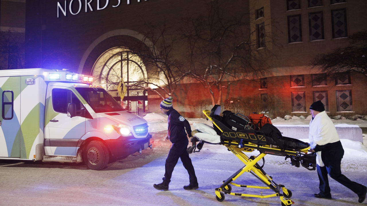 Two first responders and an ambulance are seen at the entrance to Nordstrom at the Mall of America in Bloomington, Minn.