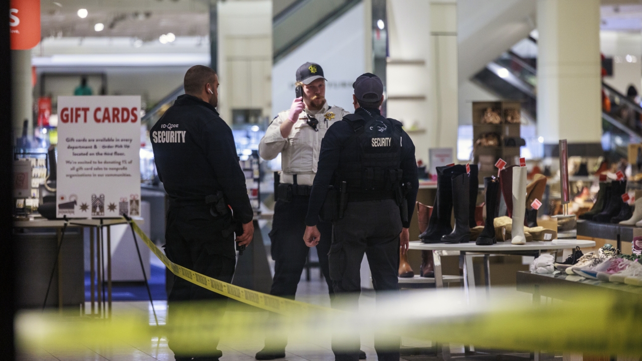 Security officers speak inside a store at the Mall of America.