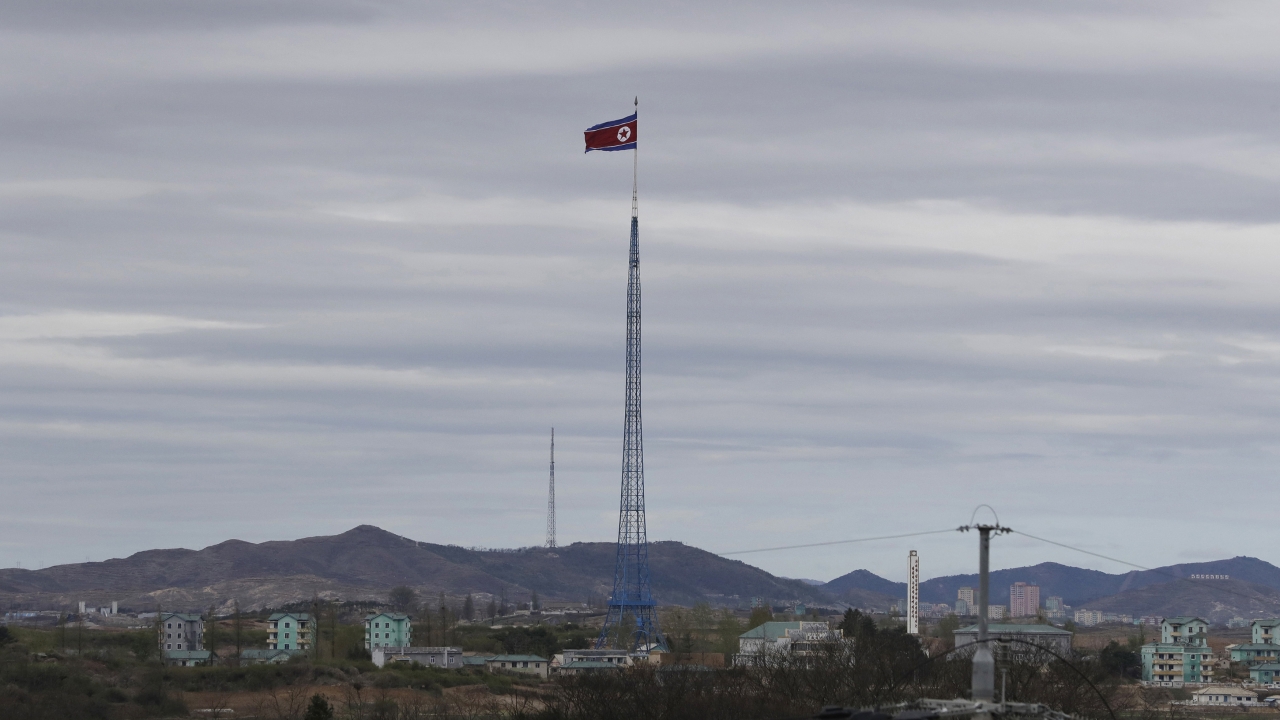 A North Korean flag flutters in the wind atop a 160-meter tower in North Korea's village Gijungdongseen.