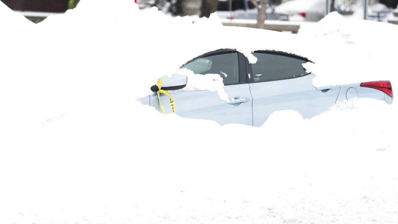 An abandoned car is covered in snow in Buffalo, New York, days after a blizzard hit.