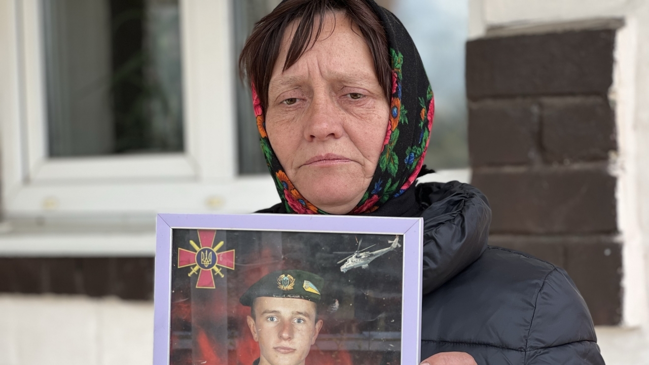 Olena Balai holds a photo of her only son, Viktor Balai, a 28-year-old veteran of the war, in Zdvyzhivka, Ukraine