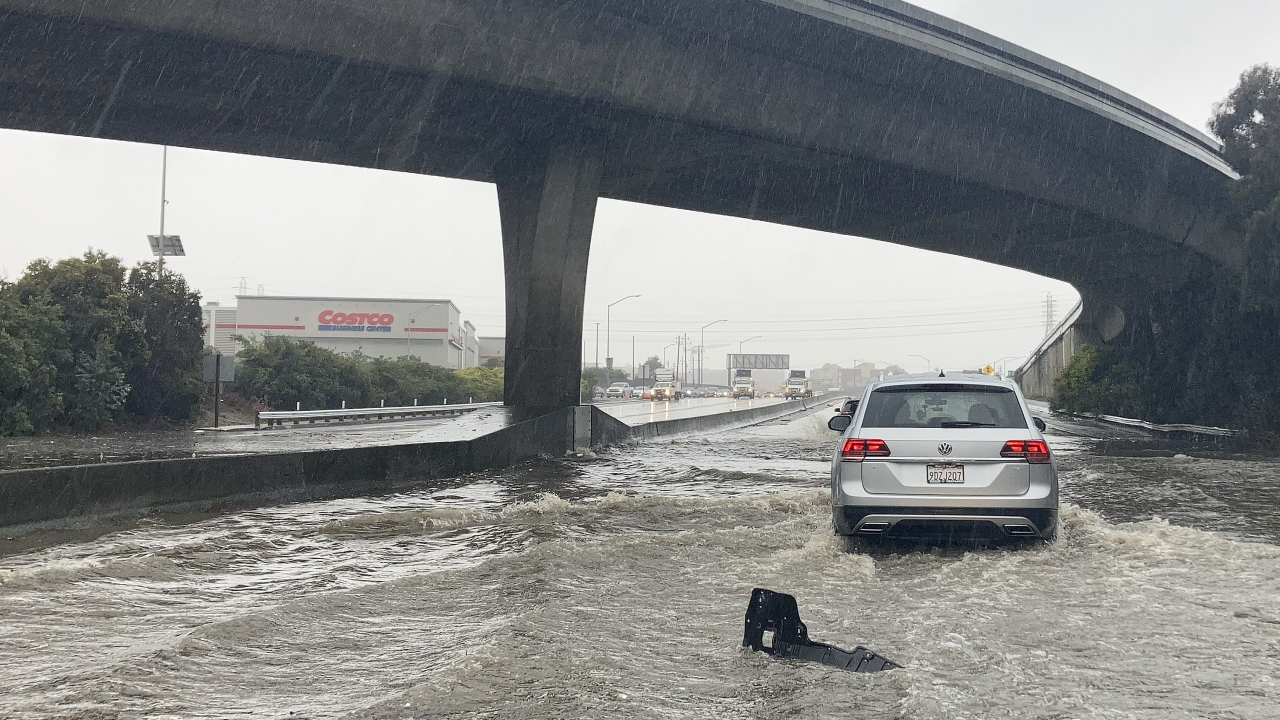 Traffic drives through flooded lanes on Highway 101.