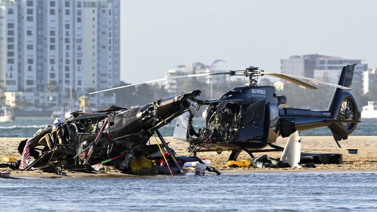 Two cashed helicopters sit on the sand at a collision scene near Seaworld, on the Gold Coast, Australia.