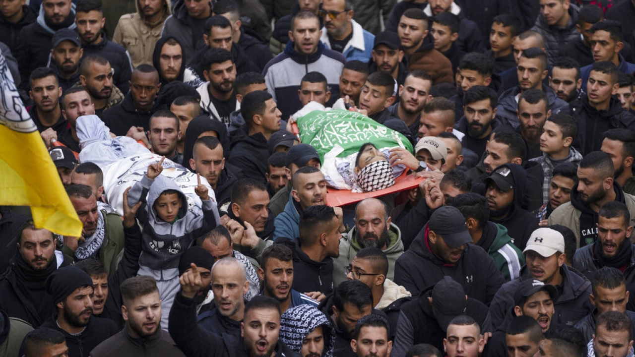 Mourners carry the bodies of Samer Houshiyeh, 21, and Fouad Abed, 25, during their funeral in the West Bank.