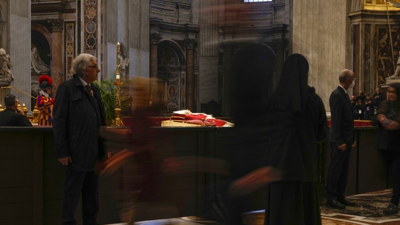 People look at the body of late Pope Emeritus Benedict XVI laid out in state inside St. Peter's Basilica at The Vatican.