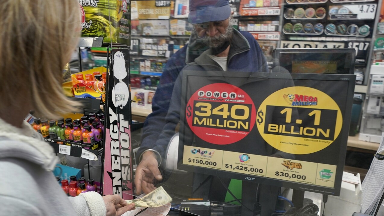 A Mega Millions customer purchases tickets