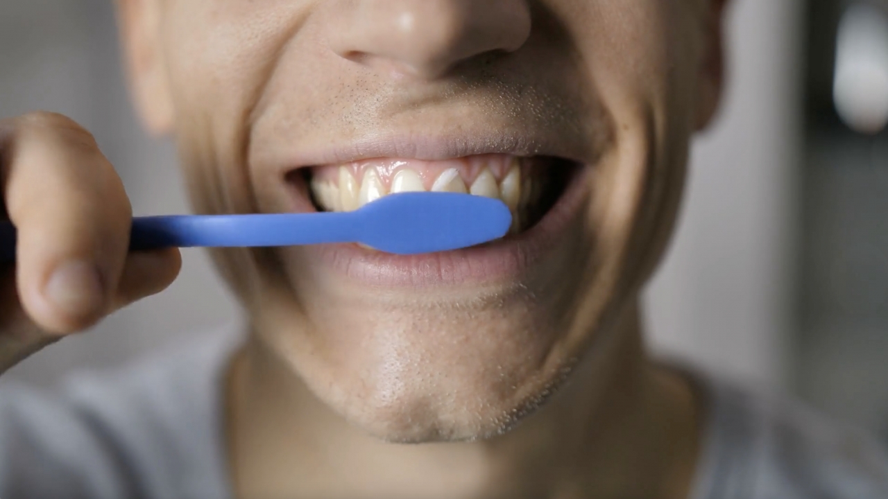 Man brushing his teeth.