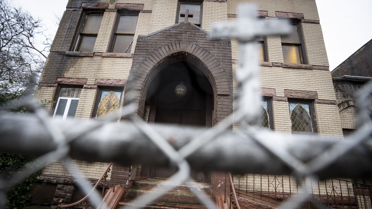A rusted fence surrounds the Varick Memorial AME Zion Church.