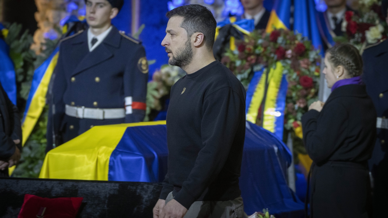 Ukrainian President Volodymyr Zelenskyy pays his respects to victims of a deadly helicopter crash during a farewell ceremony