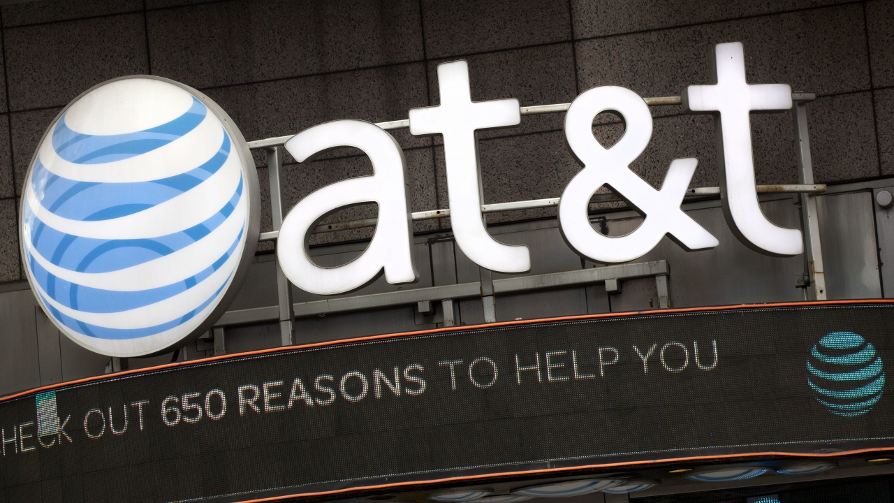 The AT&T logo is positioned above one of its retail stores.