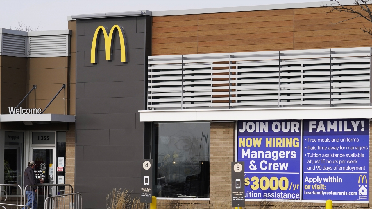 A hiring sign displayed at a McDonald's restaurant.