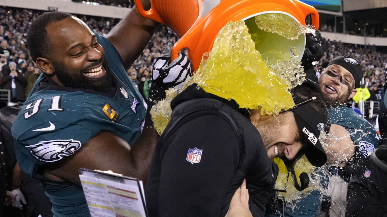 Philadelphia Eagles head coach Nick Sirianni is doused by defensive tackle Fletcher Cox (91).