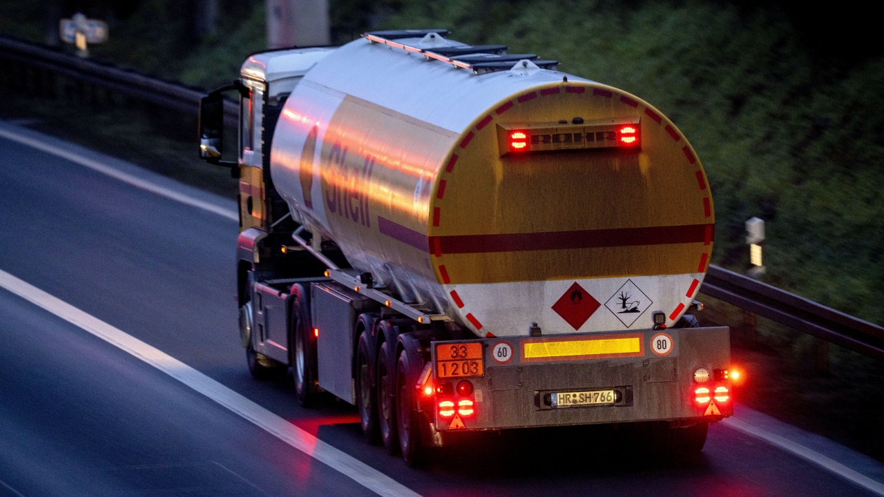 A fuel truck drives along a highway.