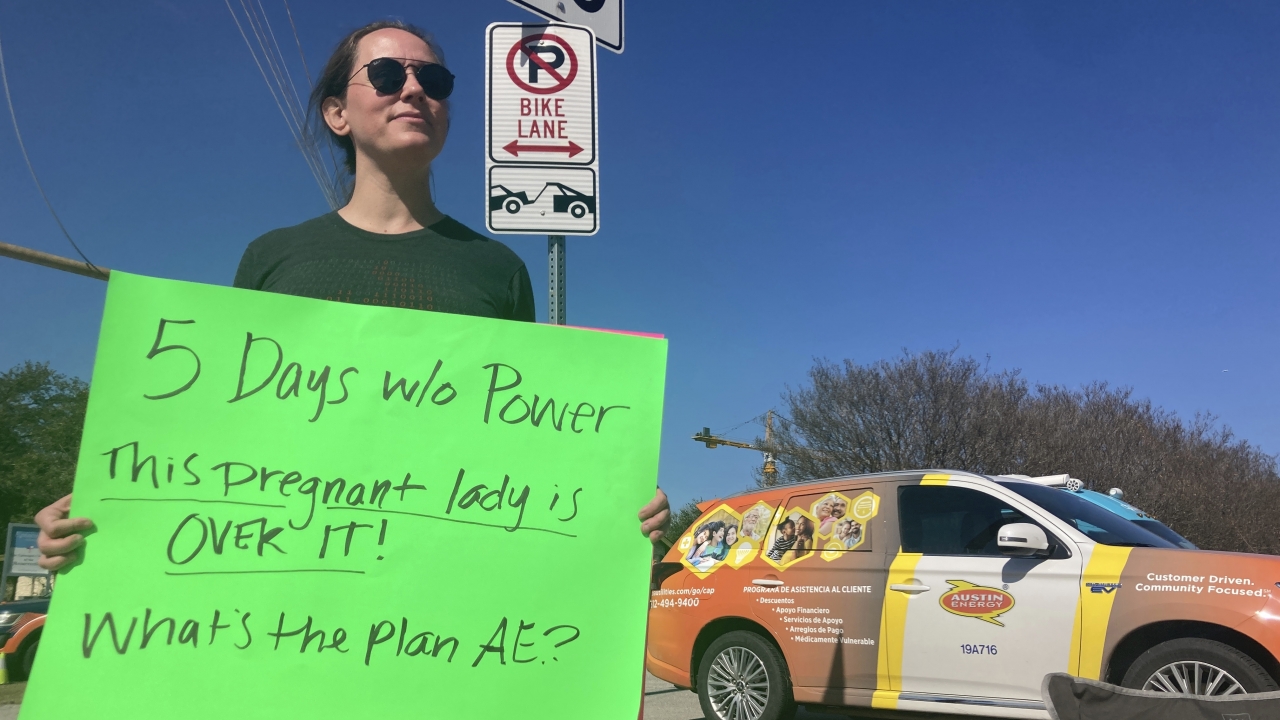 Katy Manganella protesting Austin Energy's handling of an extended power outage.