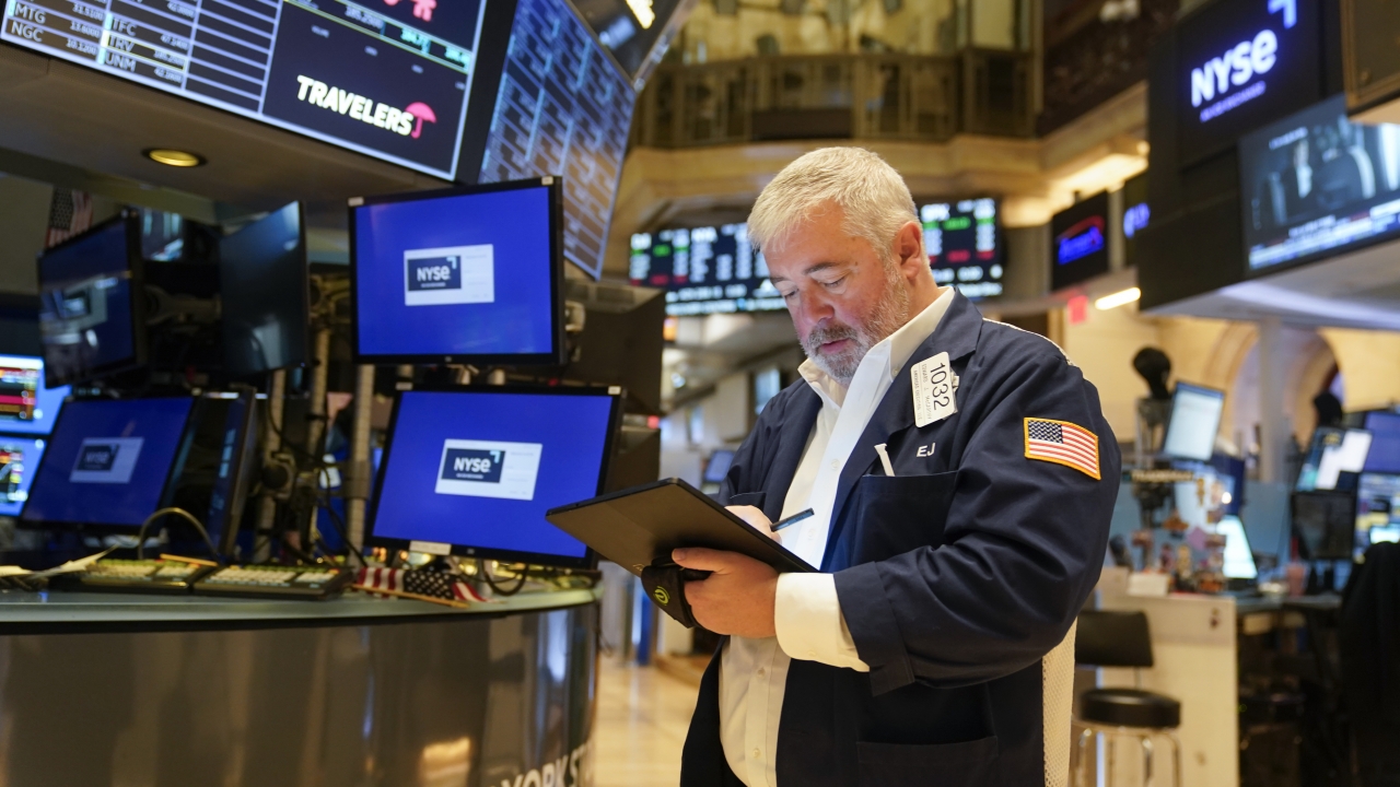 Traders work on the floor at the New York Stock Exchange in New York