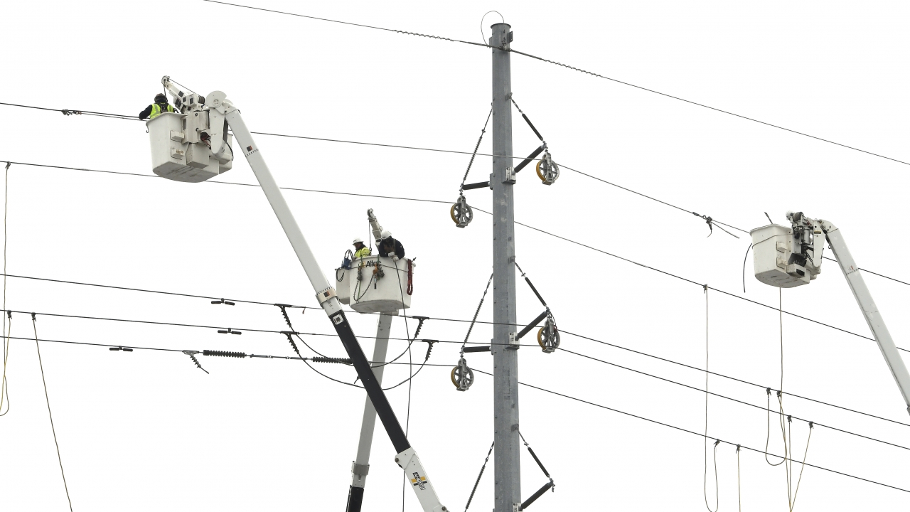 ITC Transmission, a subsidiary of DTE Energy, basket trucks work on power lines.