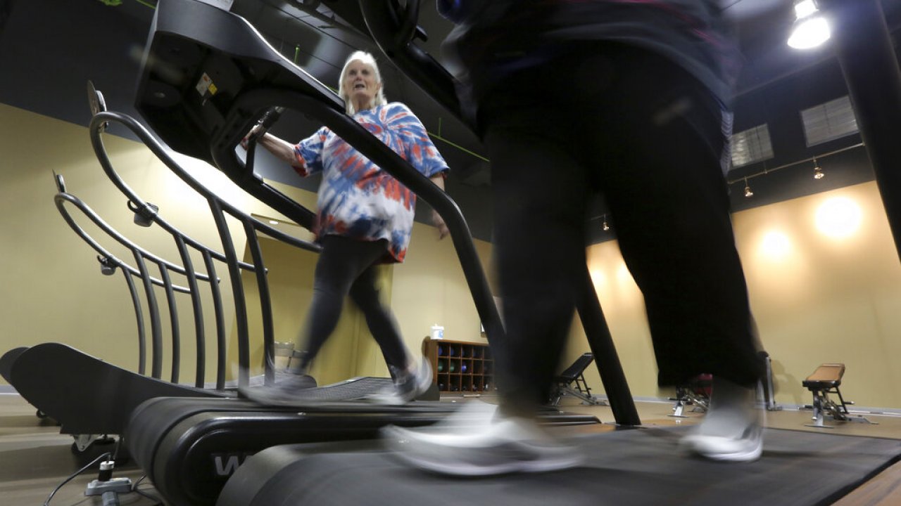 Several people walking on treadmills.