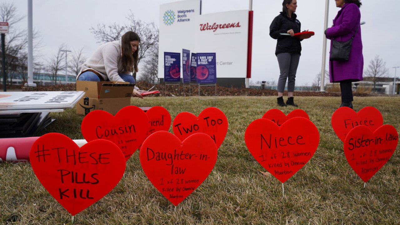Signs are seen in front of the Walgreens Deerfield headquarters during a protest over a plan to sell abortion pills.