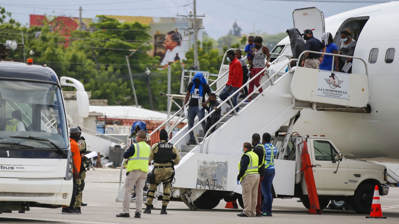 Haitians who were deported from the United States deplane.