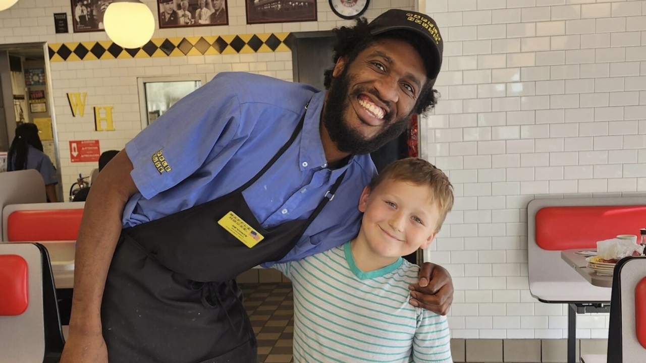 Waffle House employee has arm around little boy