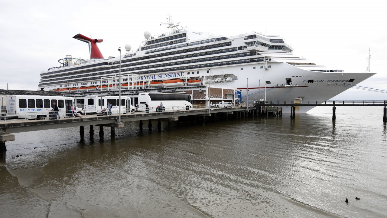 Passengers disembark from the Carnival Sunshine cruise ship Monday, March 16, 2020, in Charleston, S.C.